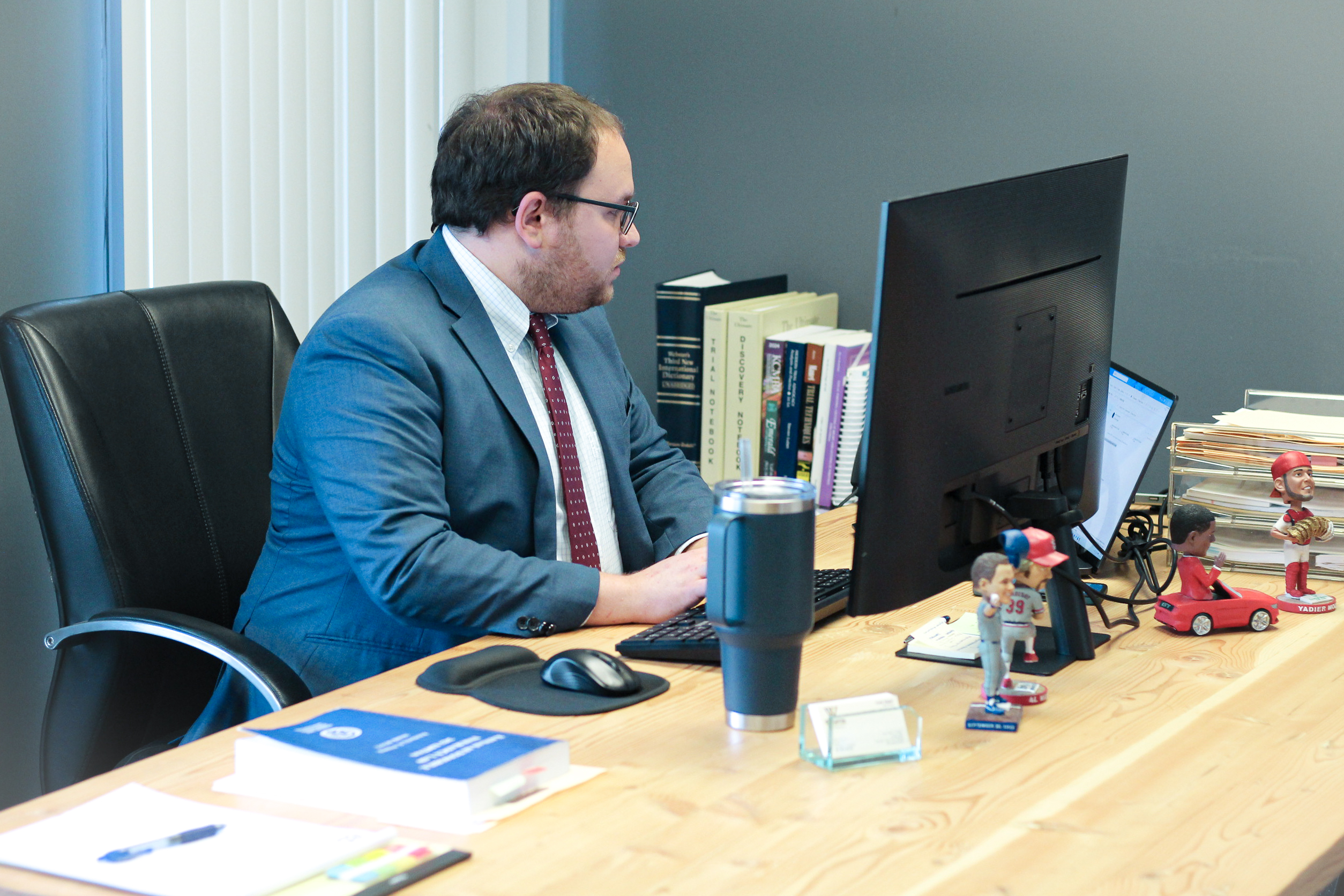 attorney hagan sits at desk- olathe car accident attorney