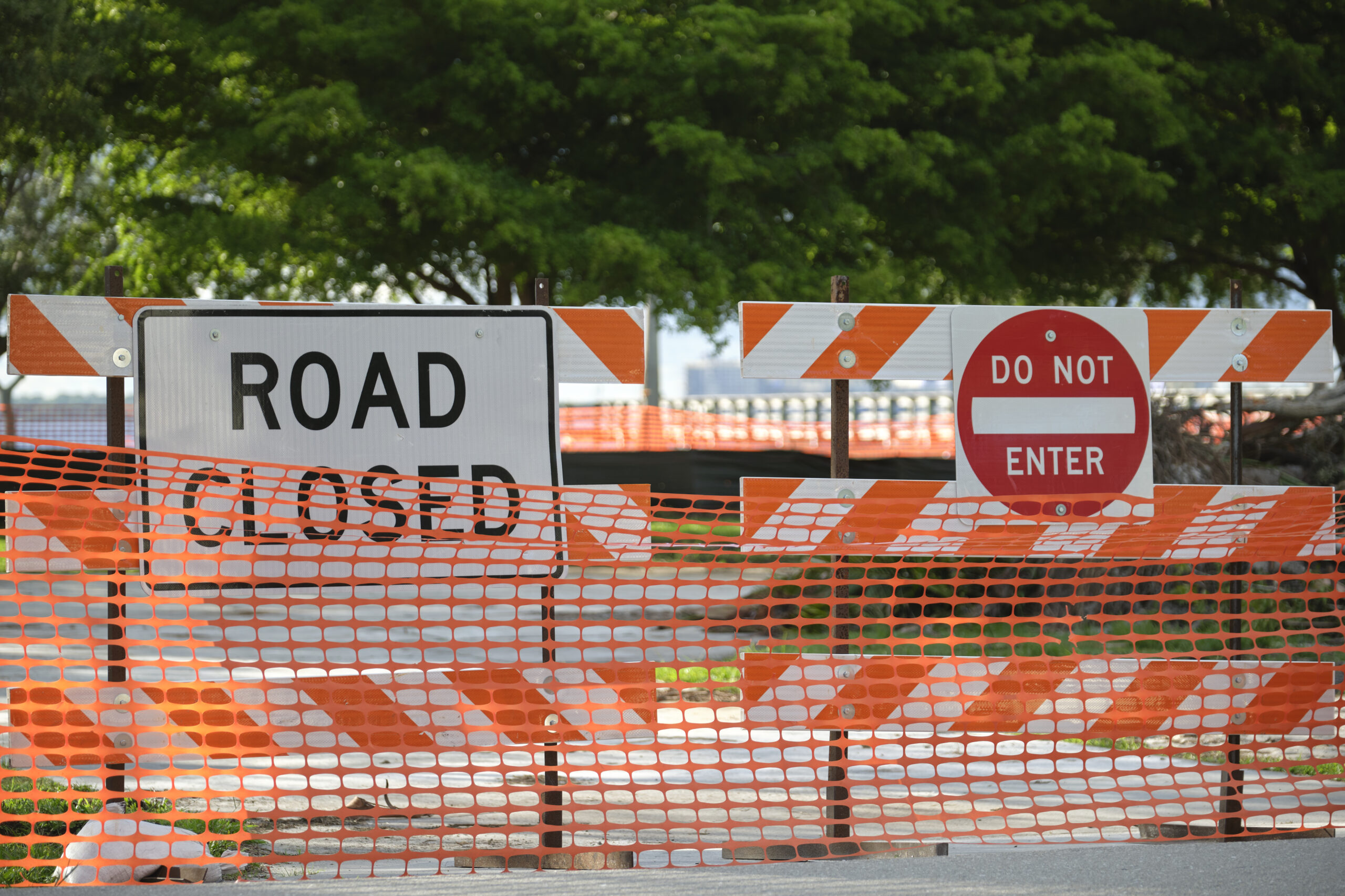 construction zone with orange barrier and road closed sign - Kansas City car accident lawyers
