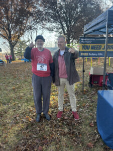 Attorney Jerry poses for picture with 5k race participant - Wallentine Injury Law 2025 Community Involvement Report