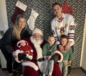 family poses for picture with Santa - Wallentine Injuyr Law 2025 Community Involvement Report